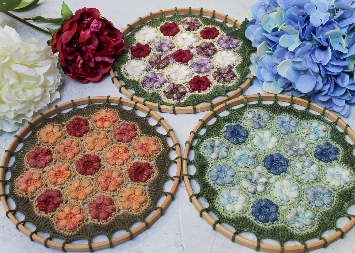 Three different Blossom Mandala colourways, Peony, Peach and Hydrangea, surrounded by flowers.