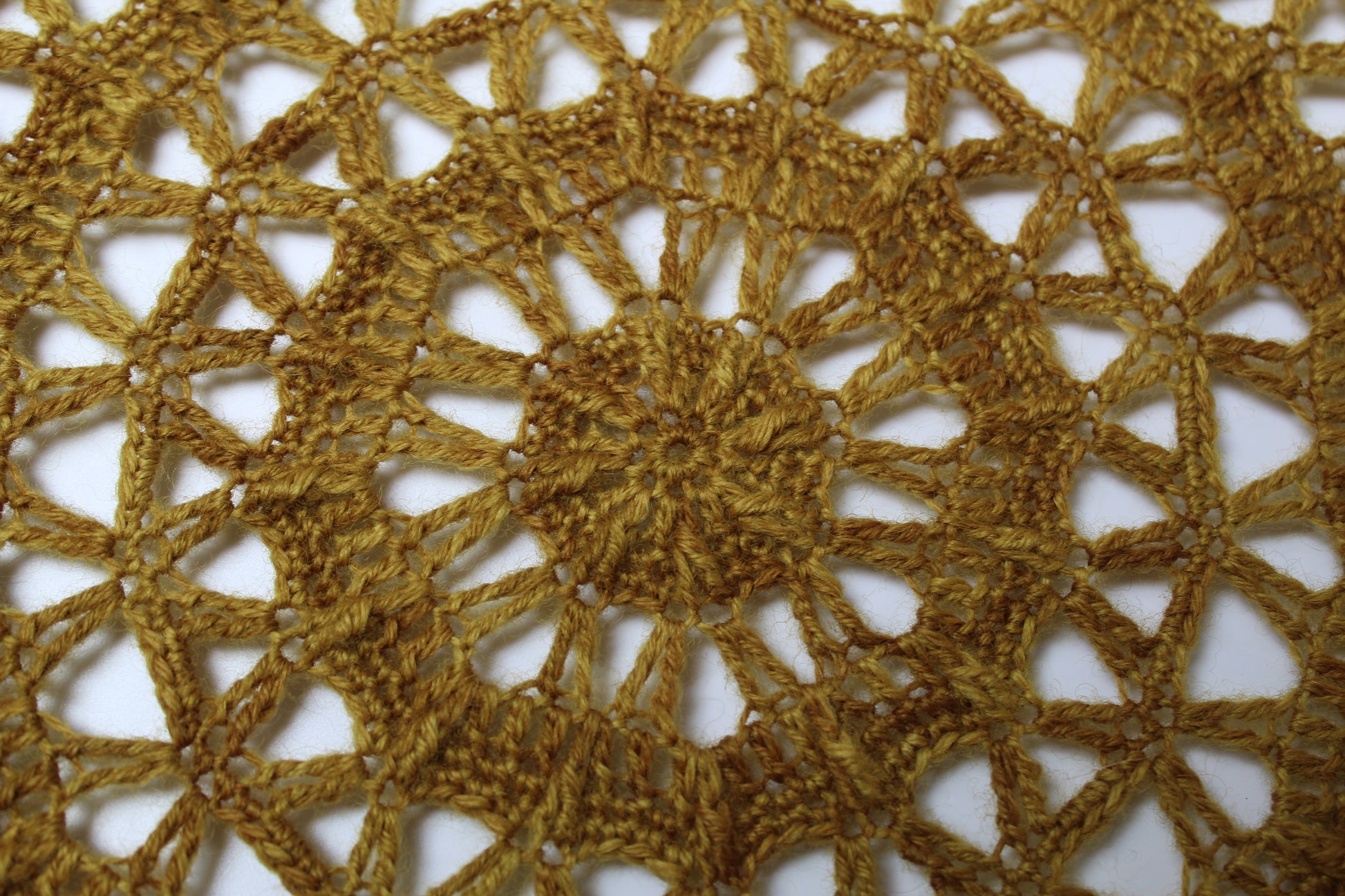 Close up mustard coloured crochet mandala