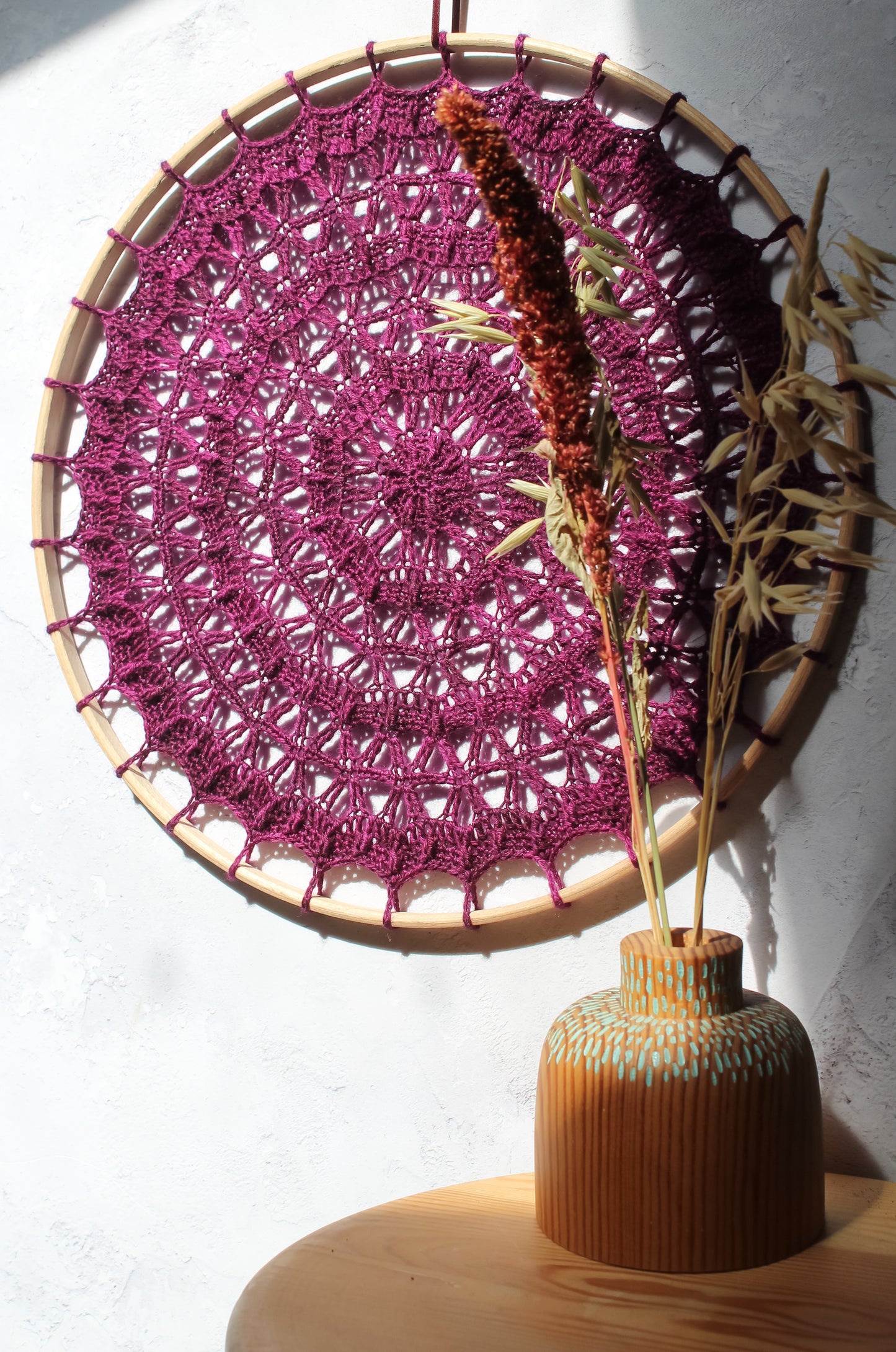 Plum coloured crochet mandala in sunlight