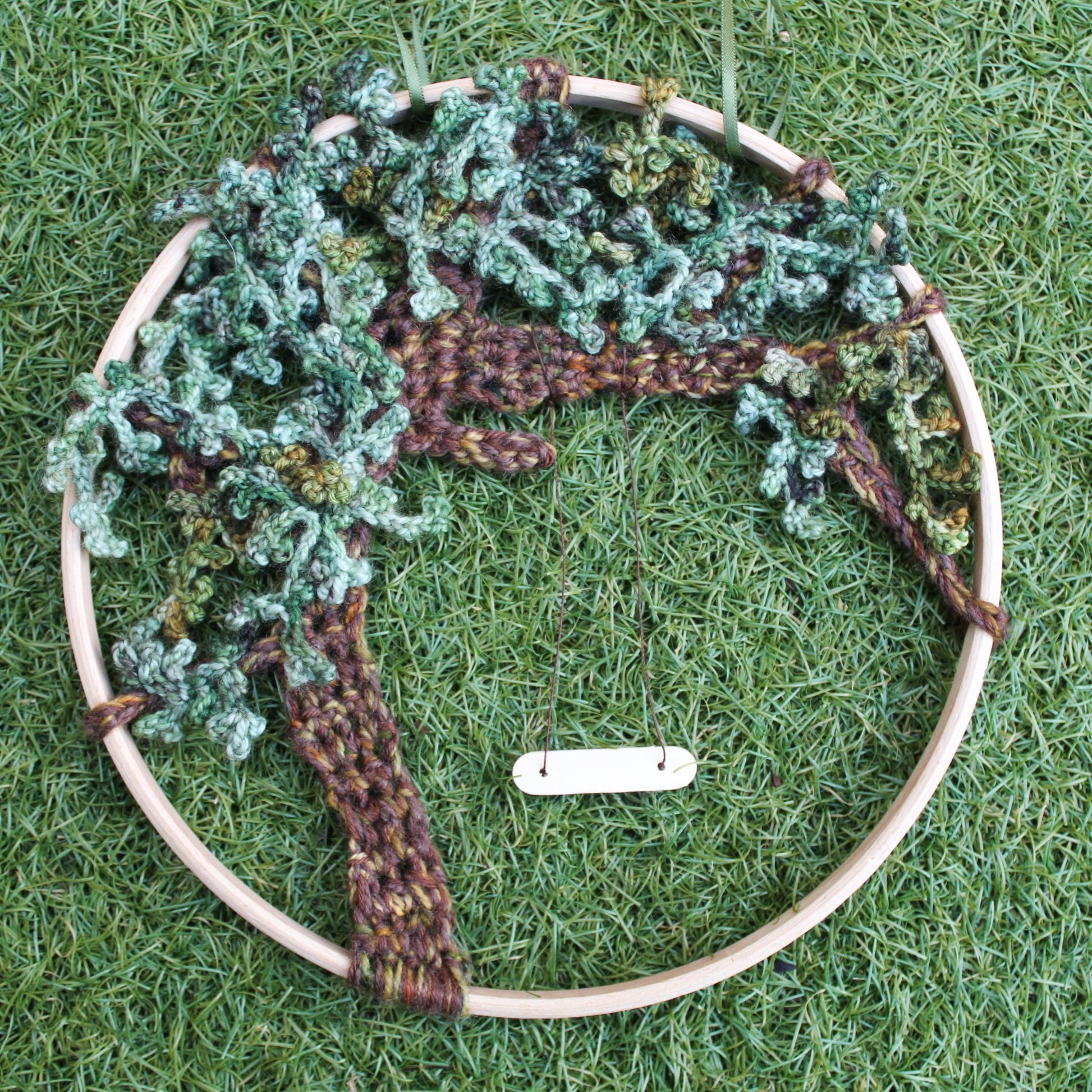 Tree mandala full of leaves with a swing hanging from a branch