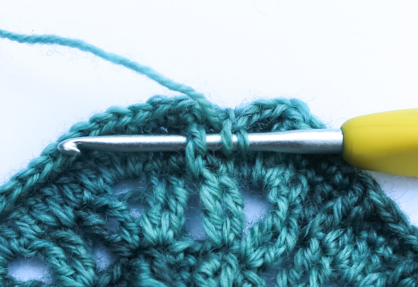 Close up of a turquoise mandala in progress